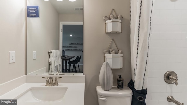 bathroom with visible vents, shower / bath combo with shower curtain, toilet, and vanity