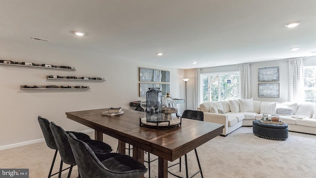 dining room featuring recessed lighting, visible vents, light carpet, and baseboards