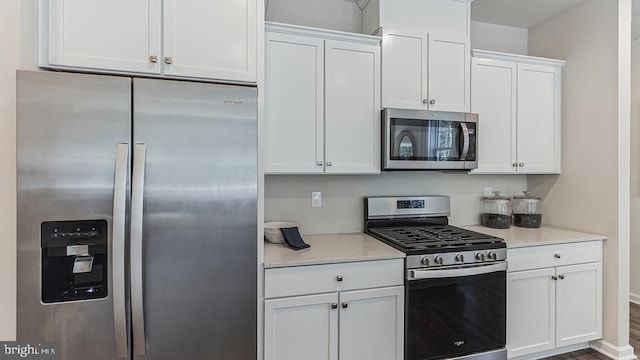 kitchen featuring appliances with stainless steel finishes and white cabinets