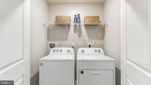 laundry area featuring separate washer and dryer and laundry area