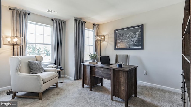 office with plenty of natural light, visible vents, and light carpet