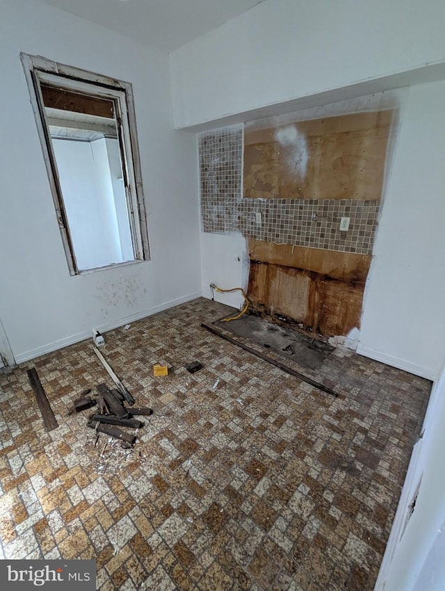 interior space featuring baseboards