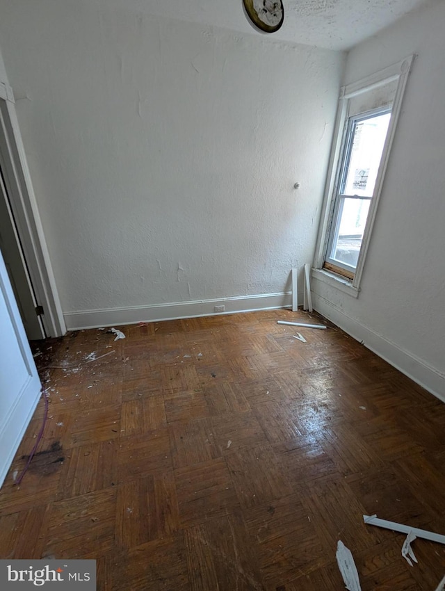 empty room featuring baseboards