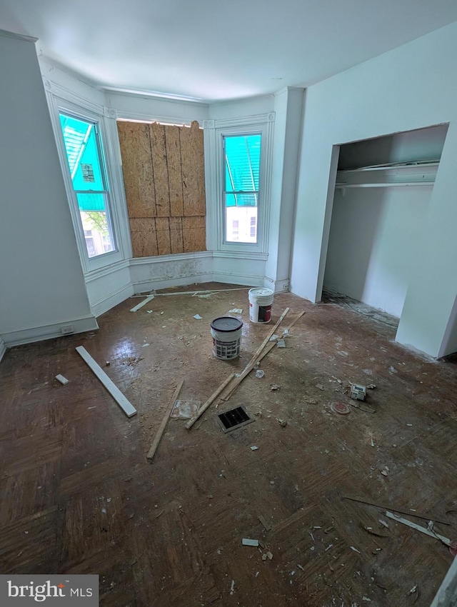 unfurnished bedroom featuring multiple windows and a closet