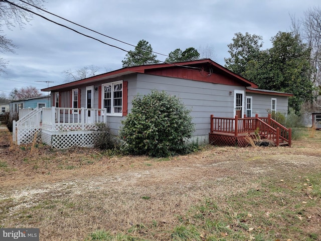 view of side of property featuring a wooden deck