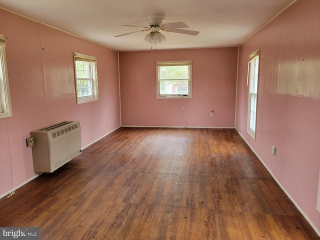 unfurnished room with a healthy amount of sunlight, wood-type flooring, and ceiling fan