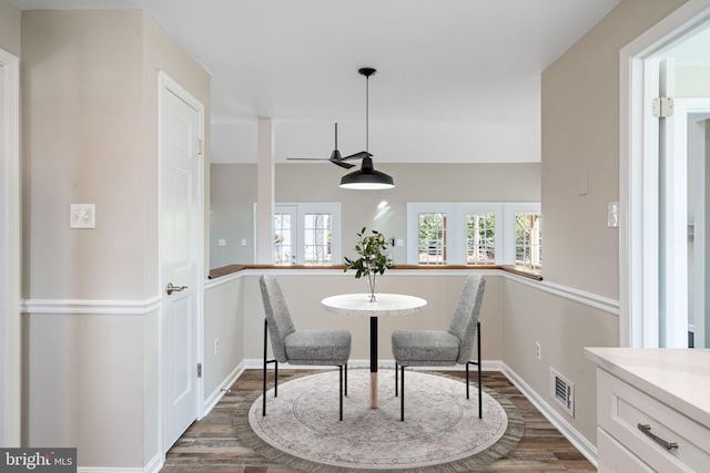 dining space featuring dark wood finished floors, baseboards, visible vents, and french doors