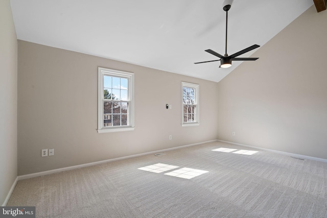 unfurnished room with visible vents, baseboards, lofted ceiling, carpet floors, and a ceiling fan