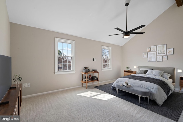 carpeted bedroom featuring high vaulted ceiling, a ceiling fan, and baseboards