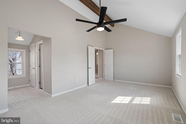 unfurnished bedroom featuring visible vents, baseboards, high vaulted ceiling, and carpet flooring