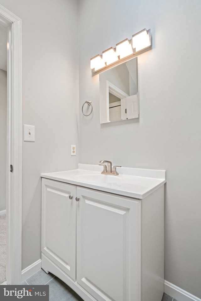 bathroom with vanity and baseboards