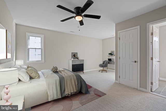 carpeted bedroom with visible vents, ceiling fan, and baseboards