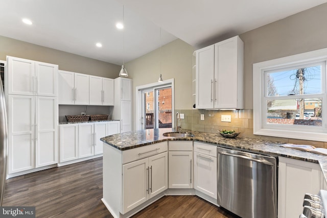 kitchen featuring a sink, stainless steel dishwasher, white cabinetry, a peninsula, and dark wood-style flooring