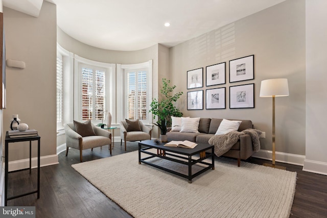 living area with recessed lighting, baseboards, and dark wood-style flooring