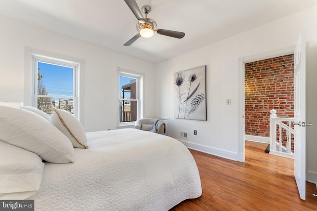 bedroom with wood finished floors, baseboards, and ceiling fan