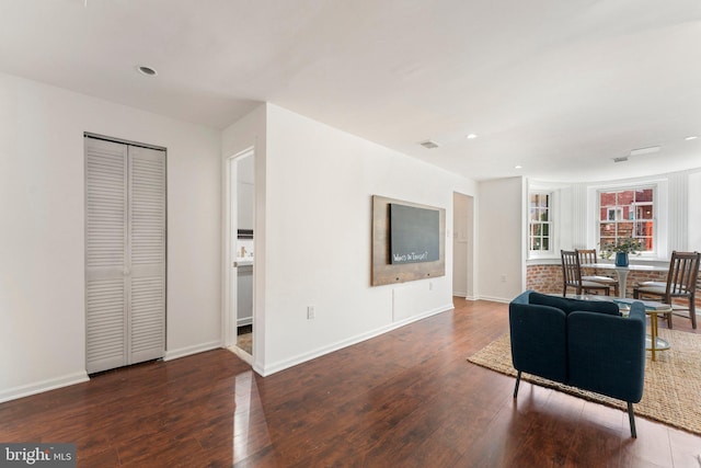 living area with hardwood / wood-style floors, recessed lighting, baseboards, and visible vents