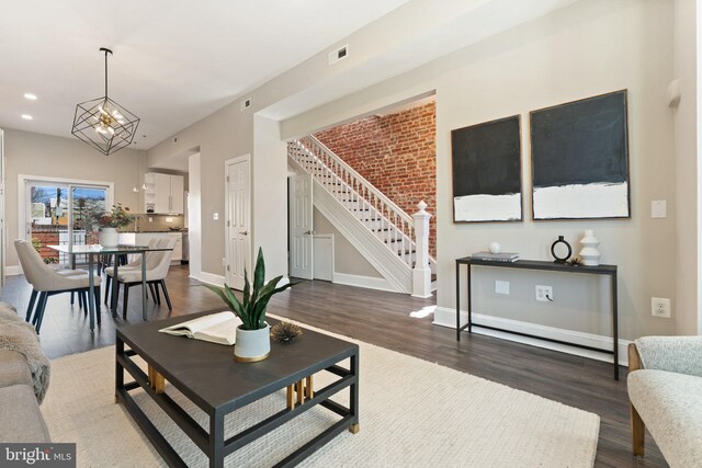 living area with visible vents, wood finished floors, recessed lighting, baseboards, and stairs