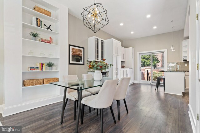 dining space featuring baseboards, built in features, recessed lighting, a notable chandelier, and dark wood-style flooring