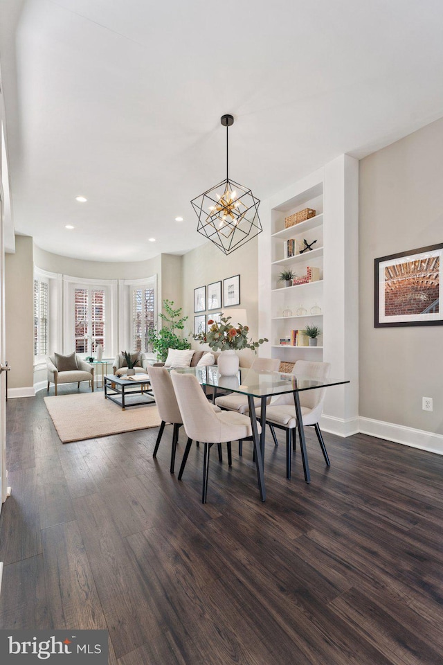 dining area with baseboards, built in features, recessed lighting, a notable chandelier, and dark wood-style flooring