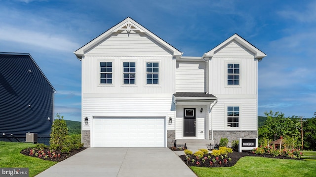 view of front facade featuring central air condition unit, stone siding, board and batten siding, concrete driveway, and an attached garage