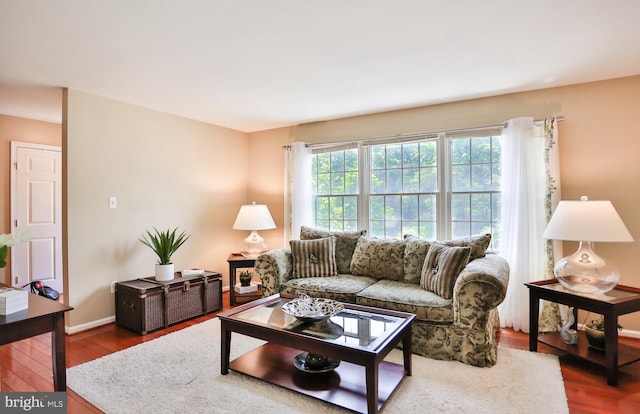 living area featuring dark wood-type flooring and baseboards