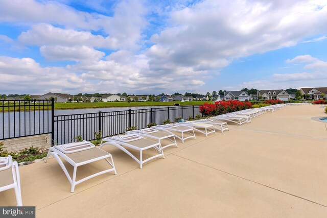 view of patio featuring a residential view and a water view