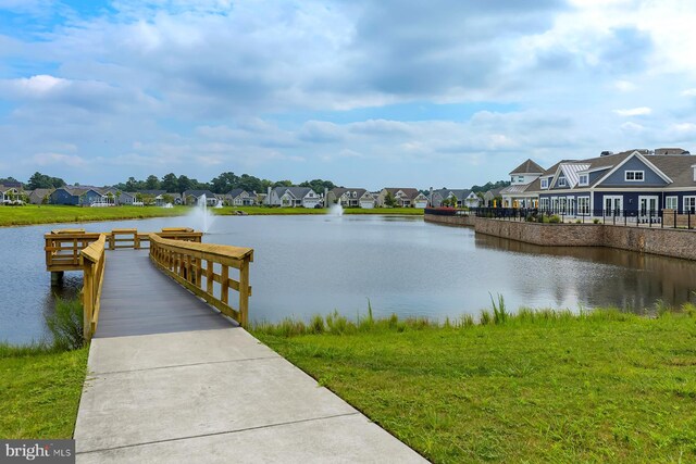 view of dock featuring a residential view and a water view