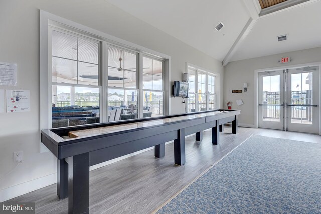 recreation room featuring visible vents, french doors, lofted ceiling, and wood finished floors