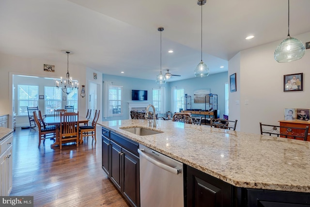 kitchen featuring a sink, open floor plan, wood finished floors, recessed lighting, and dishwasher