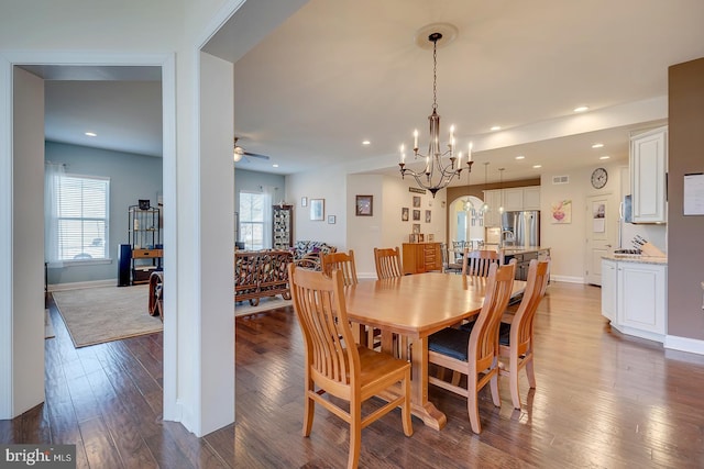 dining area featuring recessed lighting, ceiling fan with notable chandelier, and wood-type flooring