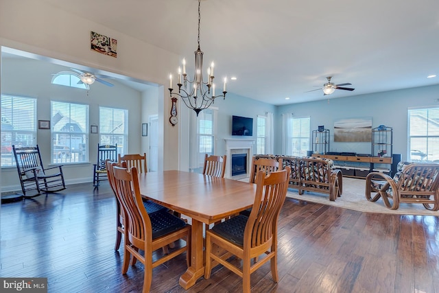 dining room with a wealth of natural light, dark wood-style floors, a fireplace, and ceiling fan