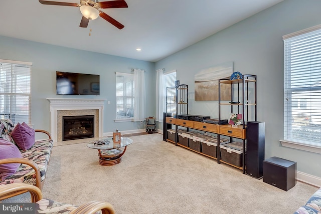 living area featuring baseboards, carpet, recessed lighting, a glass covered fireplace, and a ceiling fan