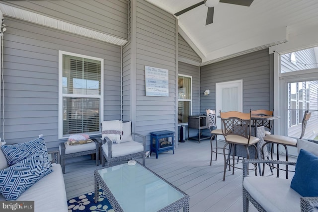 wooden deck featuring an outdoor living space and ceiling fan