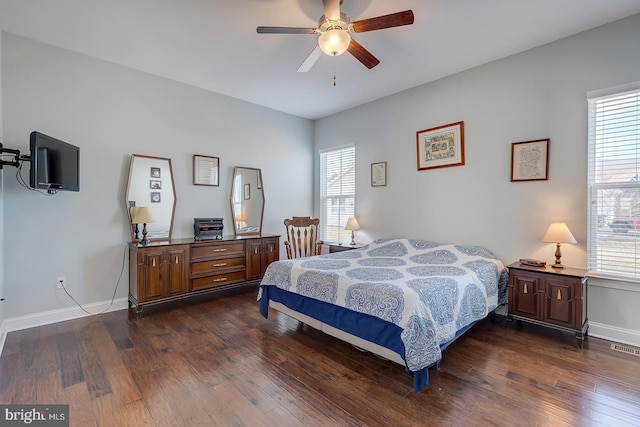 bedroom featuring dark wood-type flooring, a ceiling fan, and baseboards