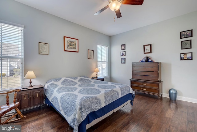 bedroom featuring a ceiling fan, baseboards, and wood finished floors