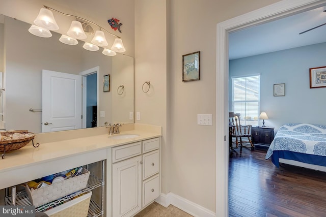 bathroom featuring vanity, wood finished floors, and baseboards