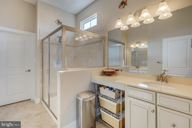 bathroom featuring tile patterned floors, a stall shower, and vanity