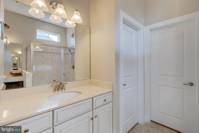 bathroom with vanity, a stall shower, tile patterned flooring, and a chandelier