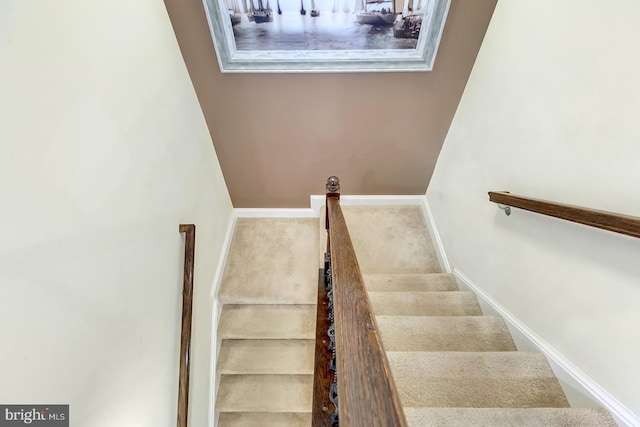 staircase featuring baseboards