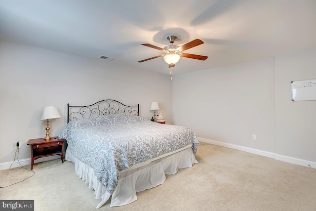 bedroom featuring light carpet, visible vents, and baseboards