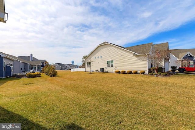 view of home's exterior featuring a yard, a residential view, and cooling unit