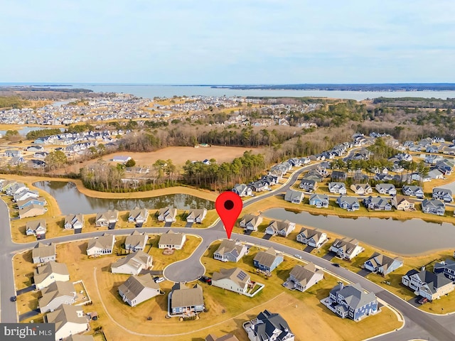 drone / aerial view featuring a residential view and a water view