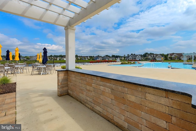 view of patio featuring a pergola and a residential view