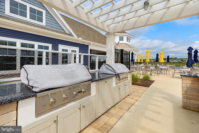 view of patio / terrace featuring grilling area, an outdoor kitchen, a pergola, and fence