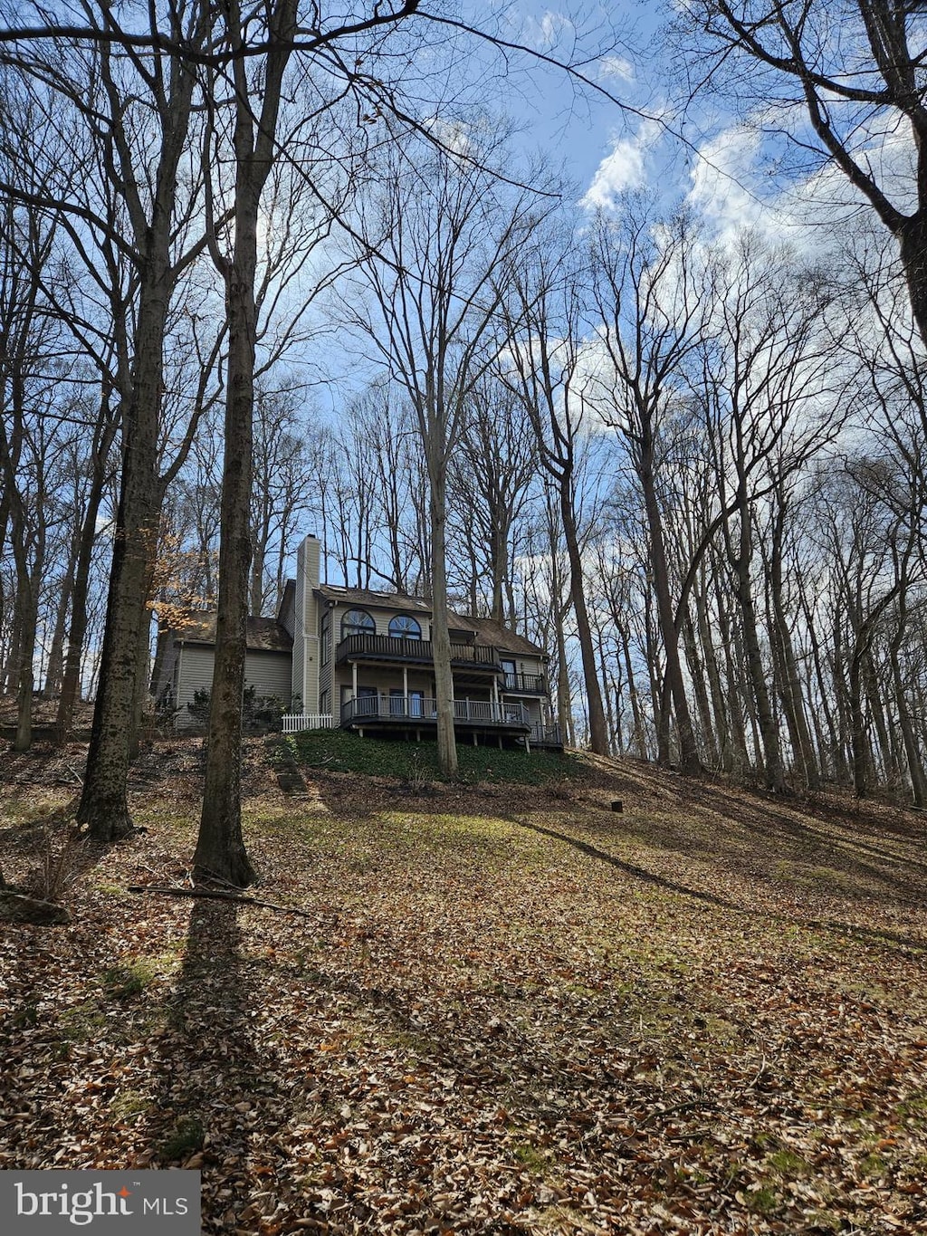 view of front of home with a deck and a chimney