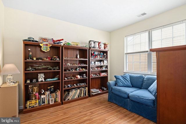 sitting room with wood finished floors and visible vents