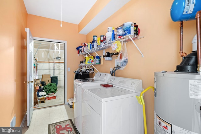 clothes washing area featuring gas water heater, independent washer and dryer, and laundry area