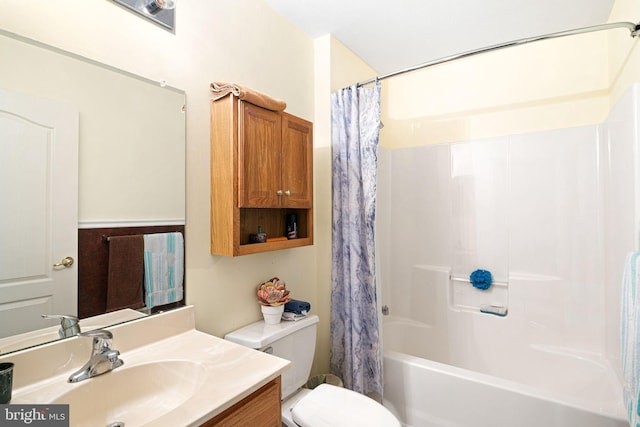 bathroom featuring vanity, shower / tub combo, and toilet