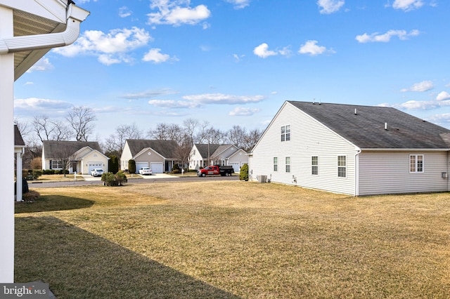 view of yard with central AC unit and a residential view