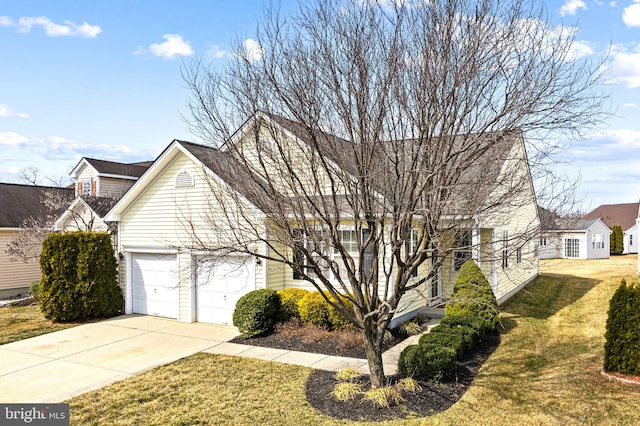 view of front of property with a garage, driveway, and a front yard